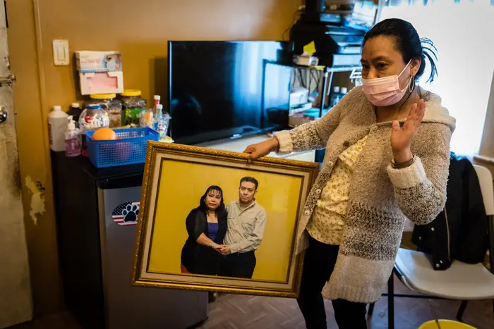 Zenaida Morales holds a portrait of herself and her husband